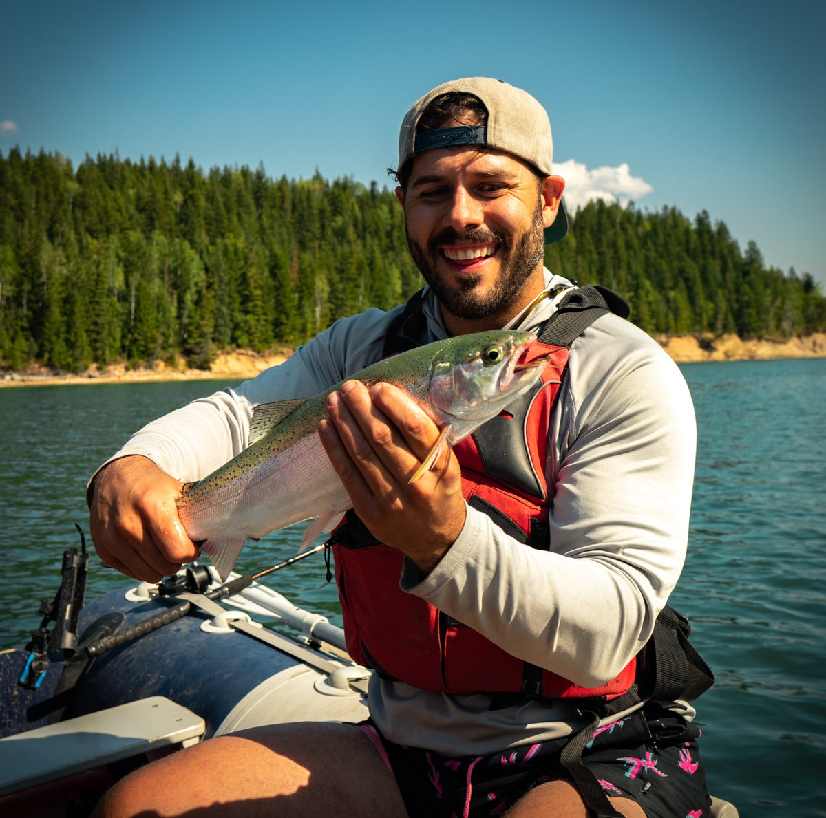 An angler holding a fish on Kinbasket Lake
