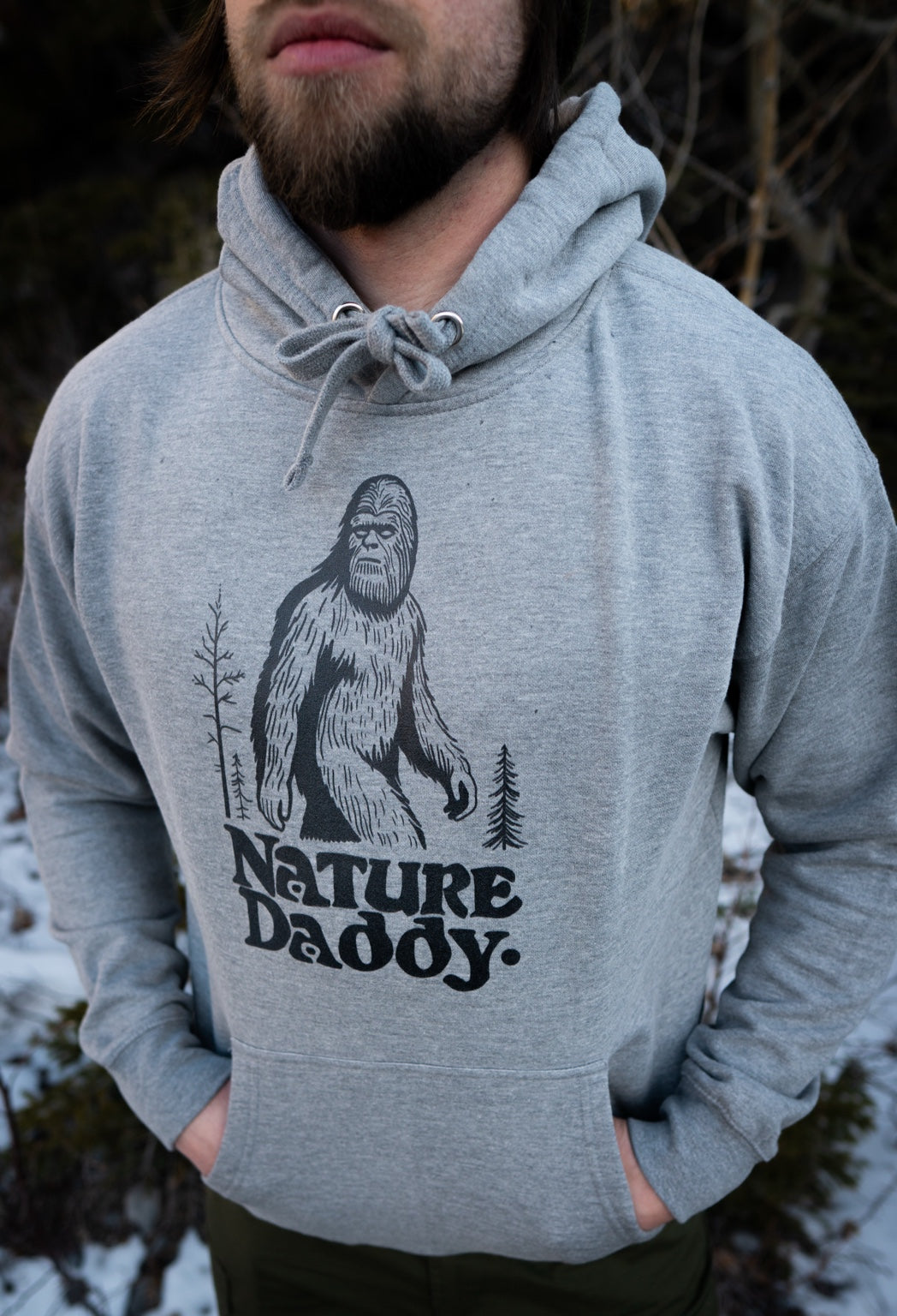Grey Nature Daddy Sasquatch hoodie worn outdoors